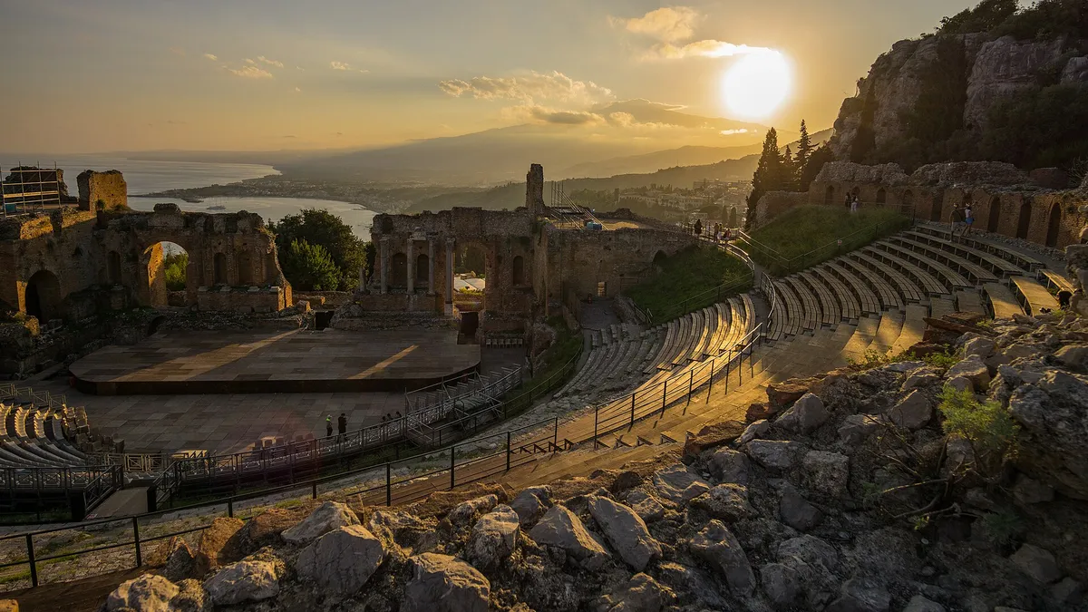 The ancient theatre of Taormina with Etna behind the stage wall
